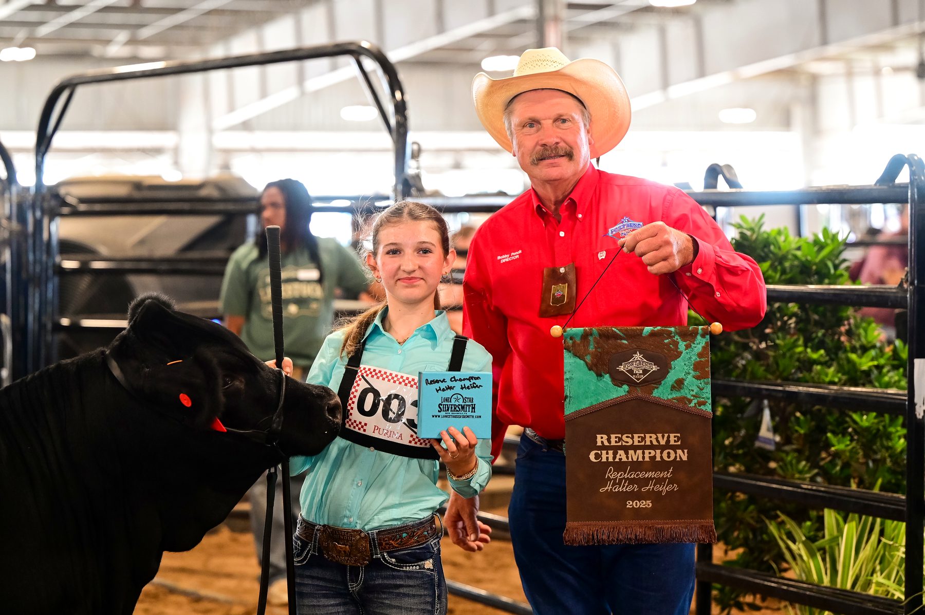 Ella leading her heifer through the show ring